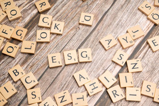 Scrabble tiles on a wooden table with the word rock